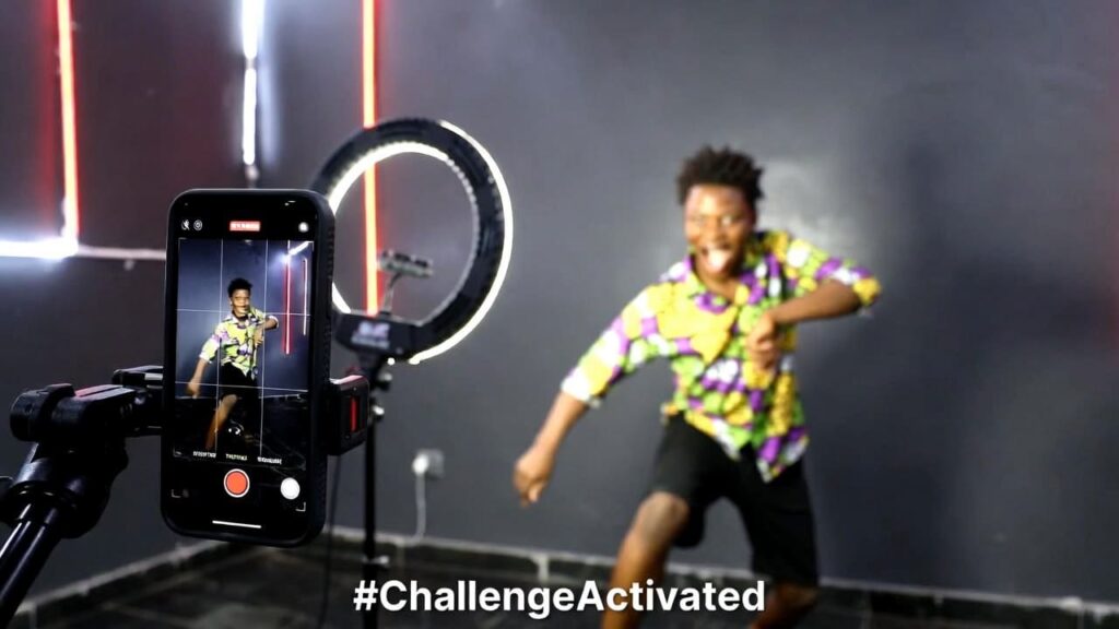 Nigerian musician filming a TikTok dance challenge video to promote a new Afrobeats song