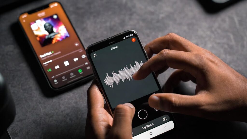 Nigerian artist planning a WhatsApp status blast music distribution campaign on phone