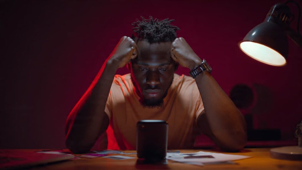 Nigerian content creator looking frustrated staring at phone with zero engagement Nigeria
