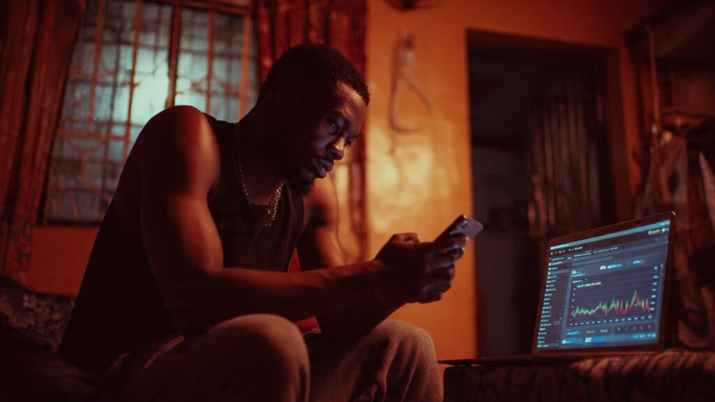 Nigerian content creator checking low engagement on phone