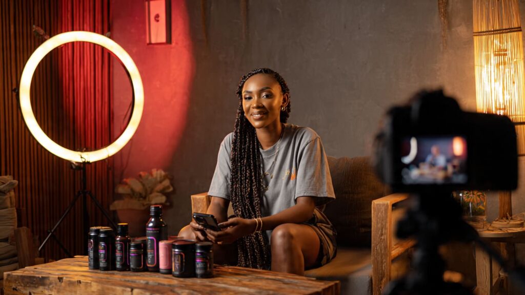 Nigerian micro-influencer recording a barter shoutout video for a Lagos-based brand